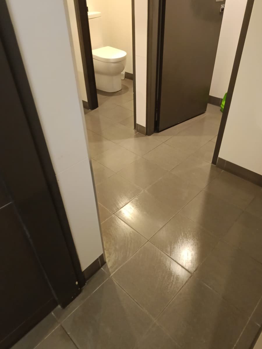 Commercial restroom floor after deep clean — tile and grout scrubbed