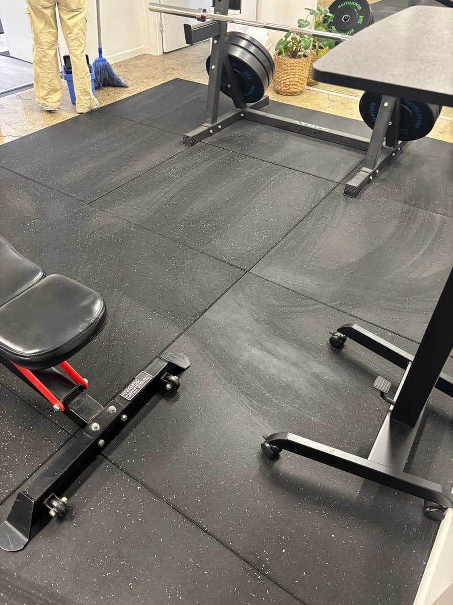 Gym floor cleaned mid-session — equipment and rubber flooring spotless