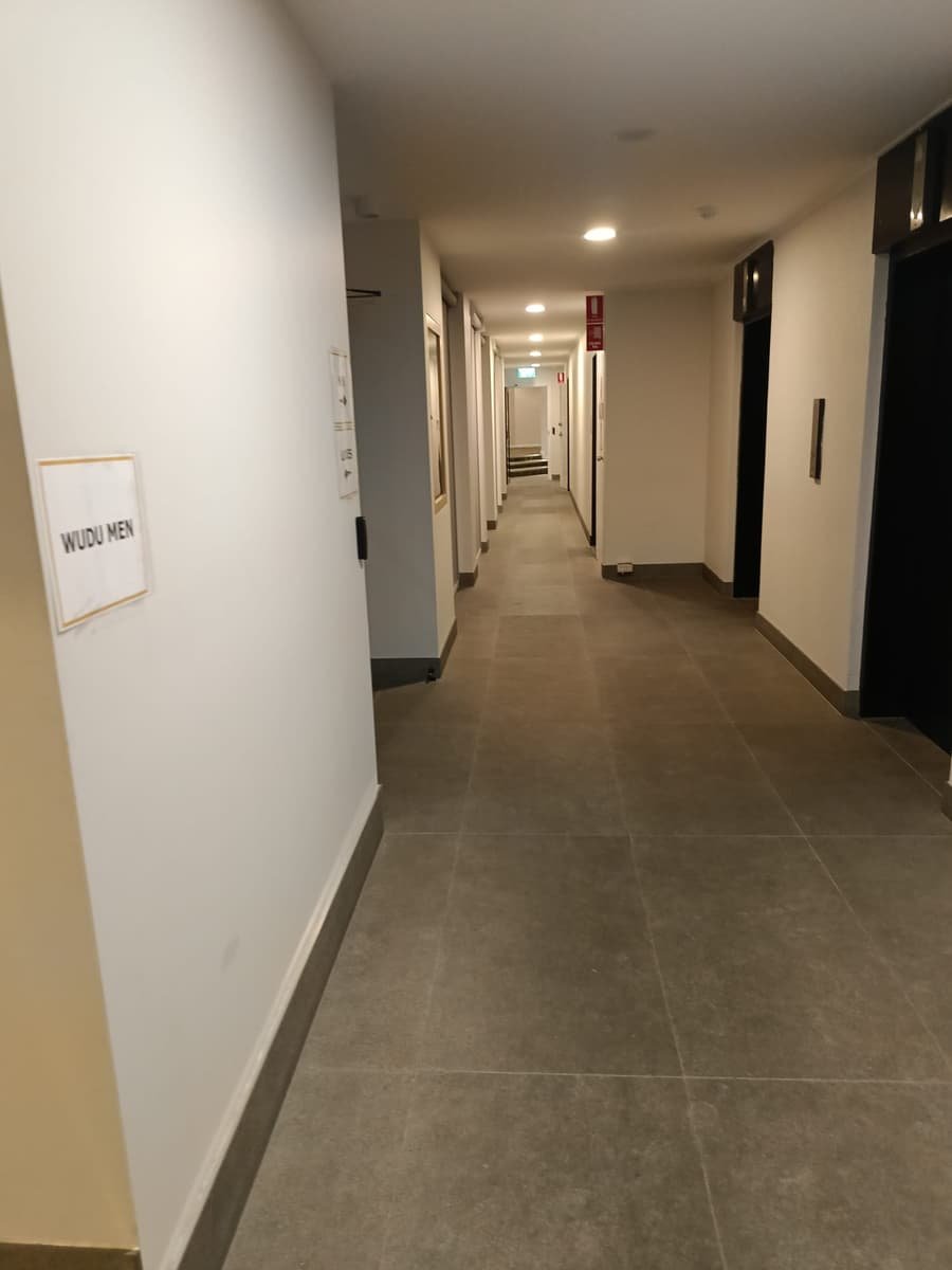 Community venue hallway after clean — spotless tiled floor